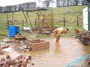 Paul washing kit off in the flood water